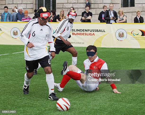 Dinc Cengiz and Russom Mulgheta of Germany battles for the ball with a player of Turkey during the Blind Football National match between Germany and...