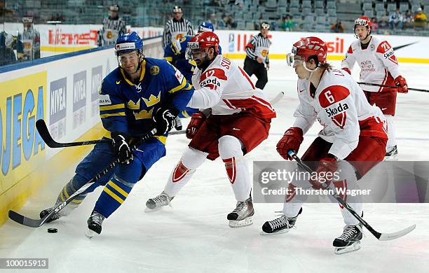 Marcus Nilson of Sweden battles for the puck with Alexander Sundberg and Stefan Lassen of Denmark during the IIHF World Championship quarter final...