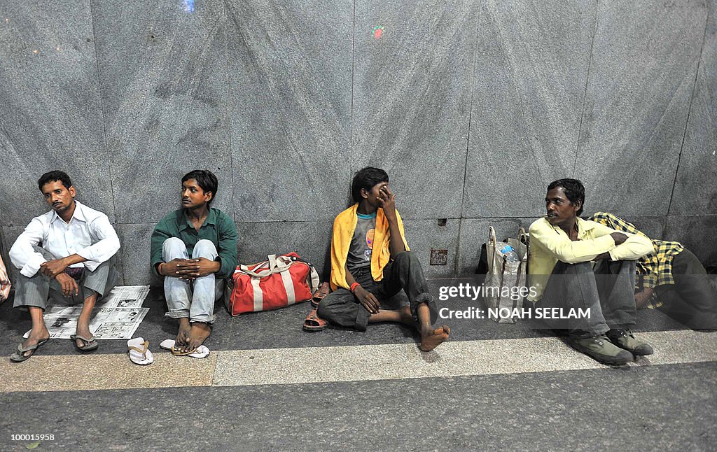 Indian passengers wait outside the Secun
