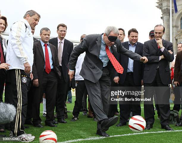 Friedhelm Julius Beucher, president of the German National Paralympic Committee handicaped with a mask, kicks a penalty on the 'Day of Blind...