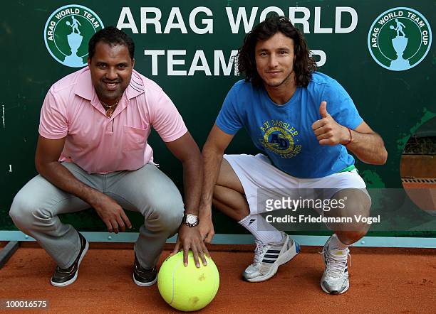 Ailton of Brazil and Juan Monaco of Argentina pose infront of the goal wall during day five of the ARAG World Team Cup at the Rochusclub on May 20,...
