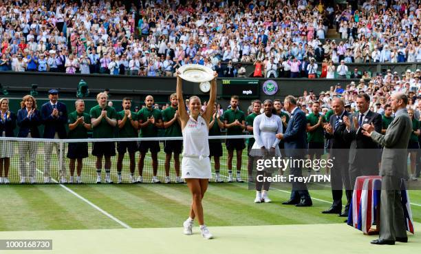 Angelique Kerber of Germany poses with the Venus Rosewater Dish after beating Serena Williams of the United States in the ladies final at the All...