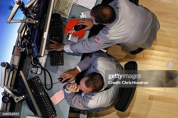 Financial professionals work at their stations on the floor of the New York Stock Exchange in the middle of the trading day May 20, 2010 in New York...