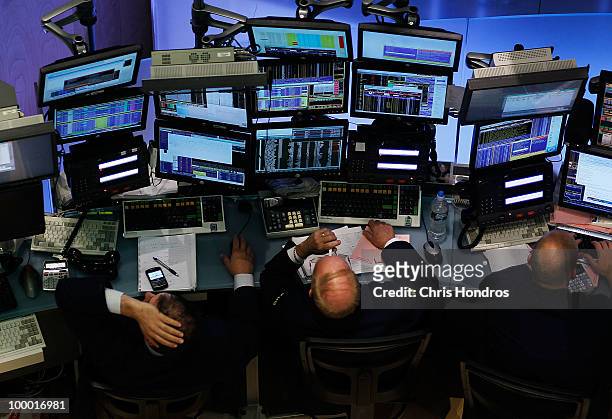Financial professionals work at stations on the floor of the New York Stock Exchange in the middle of the trading day May 20, 2010 in New York City....
