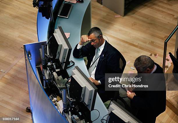 Financial professional works at a station on the floor of the New York Stock Exchange in the middle of the trading day May 20, 2010 in New York City....