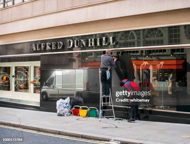 two men cleaning shop windows in mayfair, london - dunhill designer label stock pictures, royalty-free photos & images