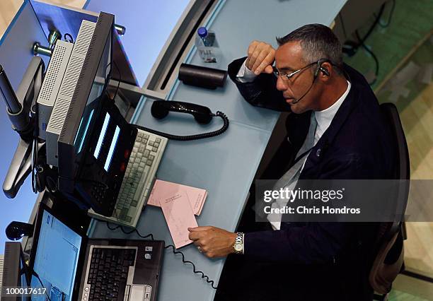 Financial professional works at a station on the floor of the New York Stock Exchange in the middle of the trading day May 20, 2010 in New York City....