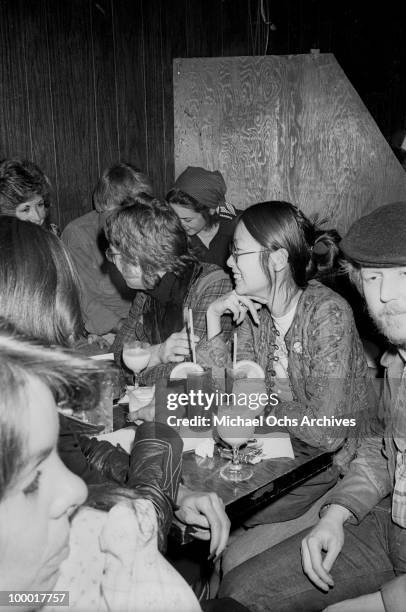 Singer-guitarist John Lennon, formerly of The Beatles, attends a Smothers Brothers comedy performance with girlfriend May Pang and fellow...