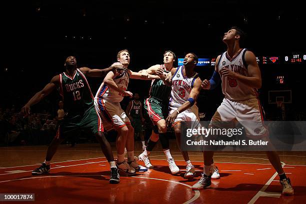 Luc Mbah a Moute and Andrew Bogut of the Milwaukee Bucks position for a rebound against David Lee, Tracy McGrady and Danilo Gallinari of the New York...