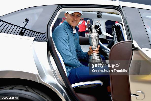 Jordan Spieth of the United States, winner of the 146th Open Championship, carries the Claret Jug onto the first tee as he returns it during previews...