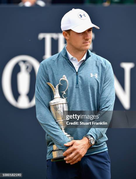 Jordan Spieth of the United States, winner of the 146th Open Championship, carries the Claret Jug onto the first tee as he returns it during previews...