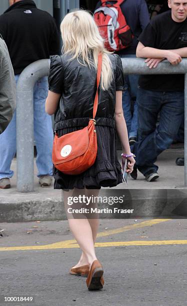 Pixie Lott smiles, waves and signs autographs through a metal fence for her Scottish fans on the other side of it, at the SECC where she is...