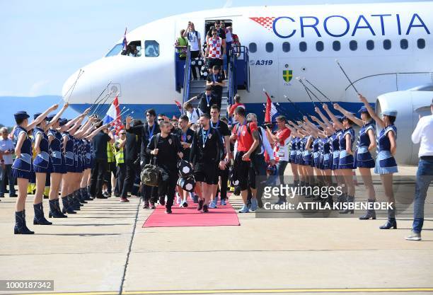 Croatian national football team members step out from their Airbus 319 airplane in Zagreb International Airport on July 16, 2018 after their return...