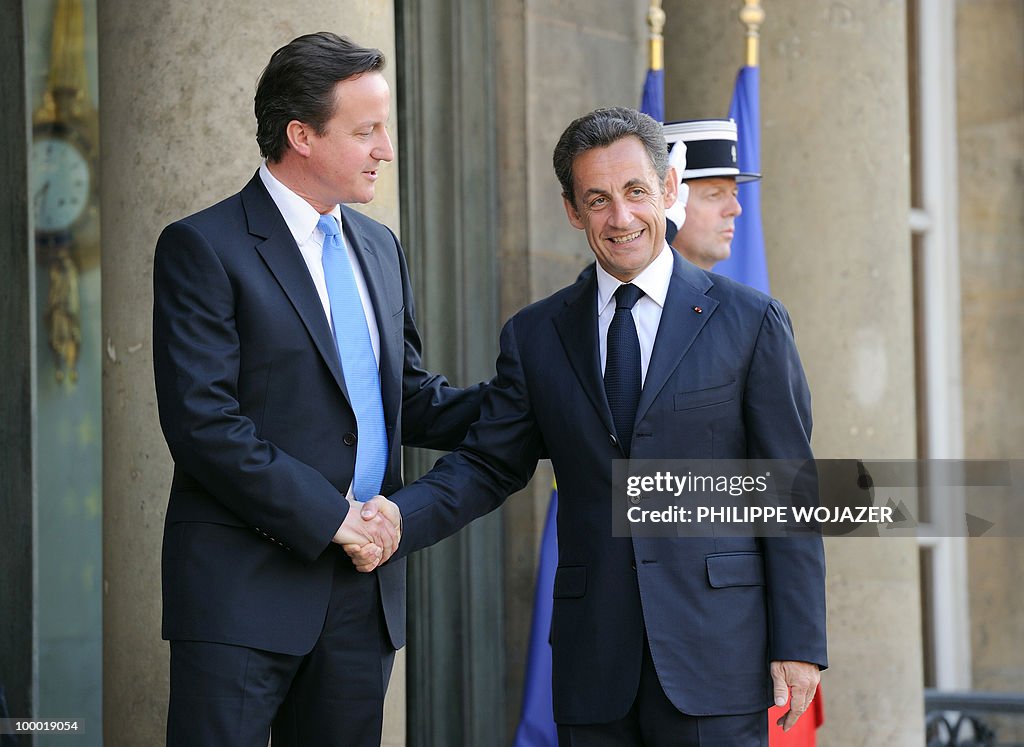 French President Nicolas Sarkozy (R) wel