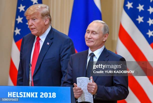 President Donald Trump and Russia's President Vladimir Putin arrive to attend a joint press conference after a meeting at the Presidential Palace in...