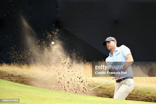 Brendan Steele of the United States plays out of a bunker on hole thirteen on a practice round during previews ahead of the 147th Open Championship...