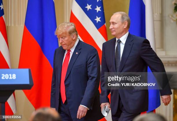 President Donald Trump and Russia's President Vladimir Putin arrive to attend a joint press conference after a meeting at the Presidential Palace in...