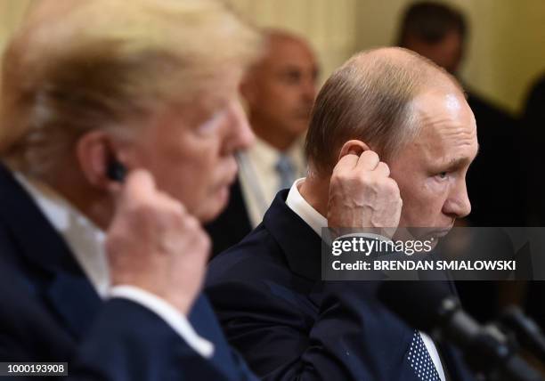 President Donald Trump and Russia's President Vladimir Putin attend a joint press conference after a meeting at the Presidential Palace in Helsinki,...