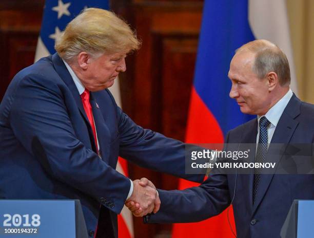 President Donald Trump and Russia's President Vladimir Putin shake hands before attending a joint press conference after a meeting at the...