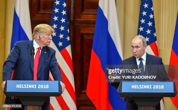 President Donald Trump listens as Russia's President Vladimir Putin speaks during a joint press conference after a meeting at the Presidential Palace...