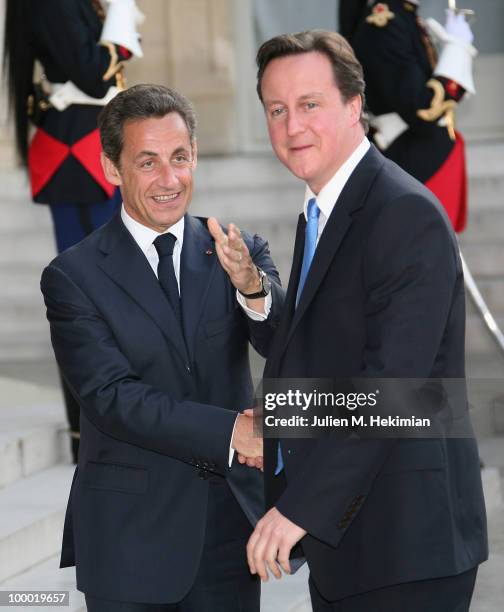 French President Nicolas Sarkozy welcomes British Prime Minister David Cameron prior to a working dinner at the Elysee Palace on May 20, 2010 in...