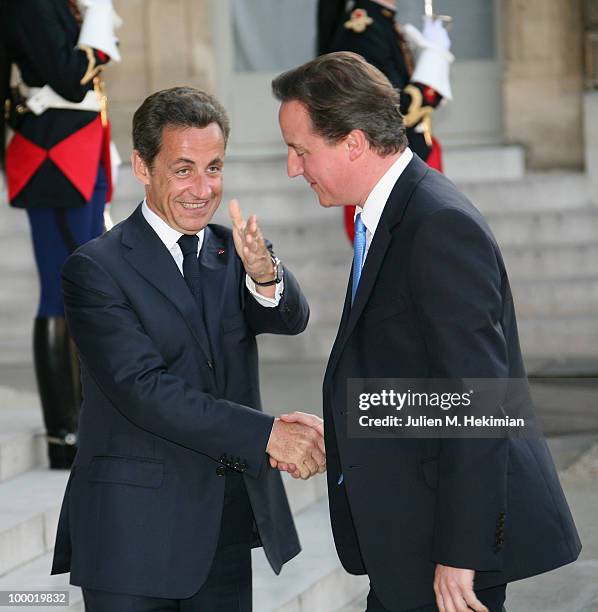 French President Nicolas Sarkozy welcomes British Prime Minister David Cameron prior to a working dinner at the Elysee Palace on May 20, 2010 in...