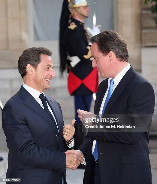 French President Nicolas Sarkozy welcomes British Prime Minister David Cameron prior to a working dinner at the Elysee Palace on May 20, 2010 in...