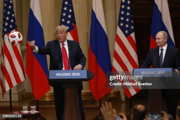 President Donald Trump throws a soccer ball Russian President Vladimir Putin gave him during a joint press conference after their summit on July 16,...