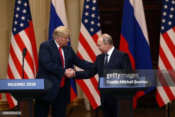 President Donald Trump and Russian President Vladimir Putin shake hands during a joint press conference after their summit on July 16, 2018 in...