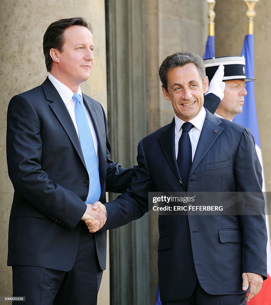 French President Nicolas Sarkozy (R) wel