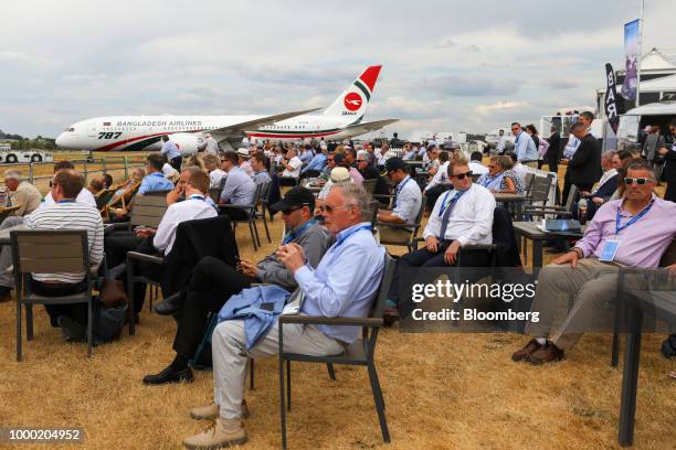 Spectators watch as a Boeing Co. 787 Dreamliner passenger aircraft, operated by Bangladesh Airlines, is taxied into position on the opening day of...