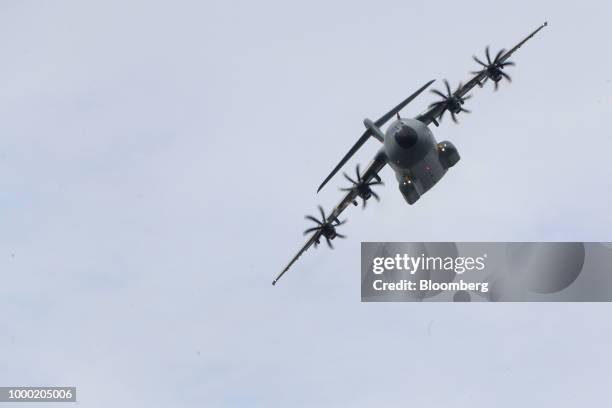 An Airbus SE A400M aircraft flies during the flying display program on the opening day of the Farnborough International Airshow 2018 in Farnborough,...