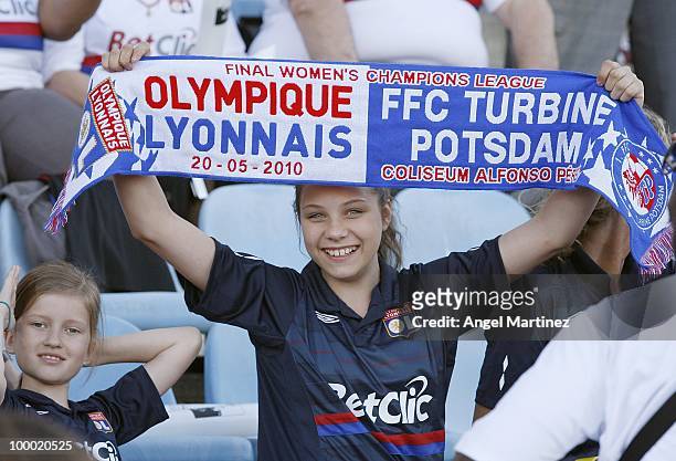 Young Lyon fan holds up a scarf before the UEFA Women's Champions League Final match between Olympique Lyonnais and FFC Turbine Potsdam at the...