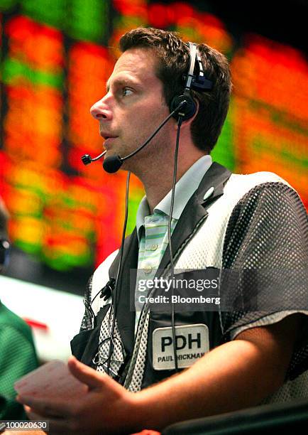 Trader Paul Hickman works in the Eurodollar options trading pit at CME Group Inc.'s Chicago Board of Trade in Chicago, Illinois, U.S., on Thursday,...