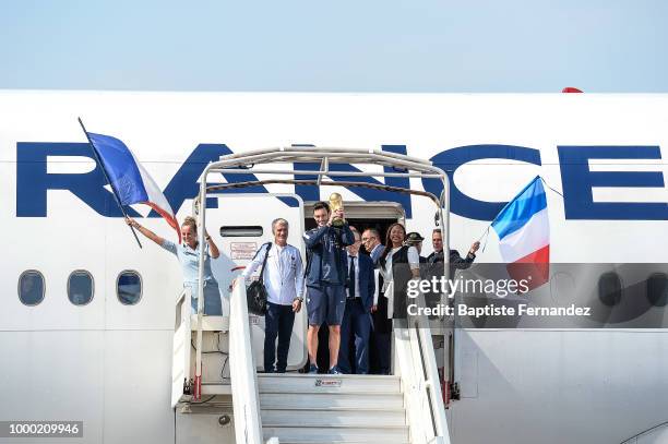 Didier Deschamps head coach, Noel Le Graet, president of French federation and Hugo Lloris of France with the trophy during the arrival at Airport...