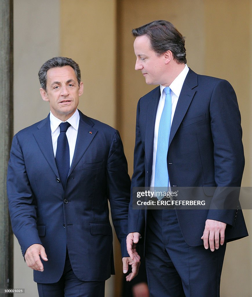French President Nicolas Sarkozy (L) acc