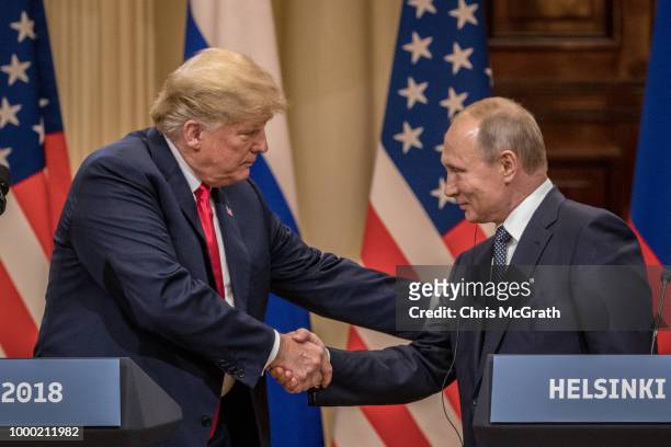 President Donald Trump and Russian President Vladimir Putin shake hands during a joint press conference after their summit on July 16, 2018 in...