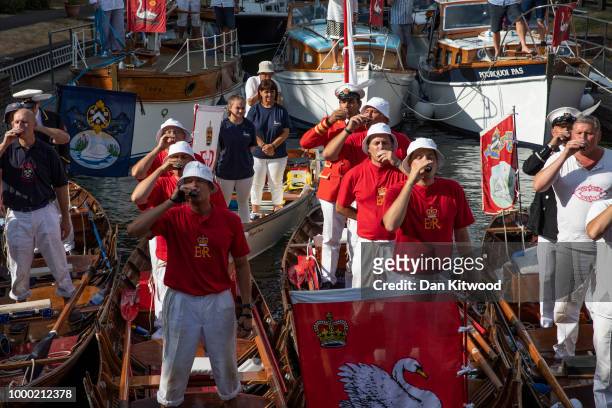 Teams raise a toast to the Queen at the end of the first day of the annual Swan Upping census on July 16, 2018 on the River Thames, South West...