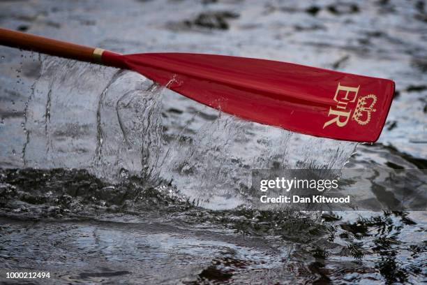 Swan Uppers' make their way down the River Thames in a rowing boat during the annual Swan Upping census on July 16, 2018 on the River Thames, South...