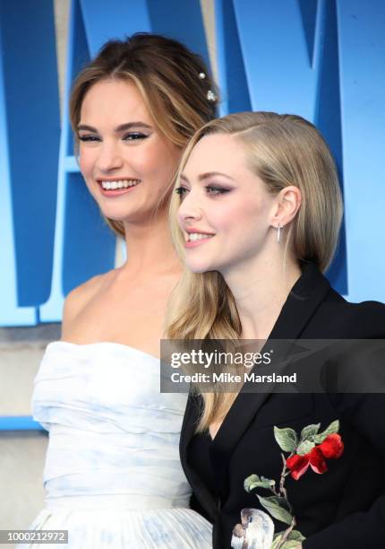 Lily James and Amanda Seyfried attend the World Premiere of "Mamma Mia! Here We Go Again" at Eventim Apollo on July 16, 2018 in London, England.