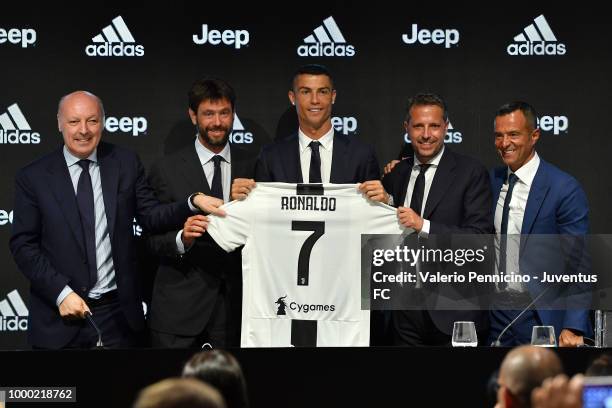 Juventus new signing Cristiano Ronaldo poses for the media with Giuseppe Marotta, Andrea Agnelli, Fabio Paratici and Jorge Mendes during the press...