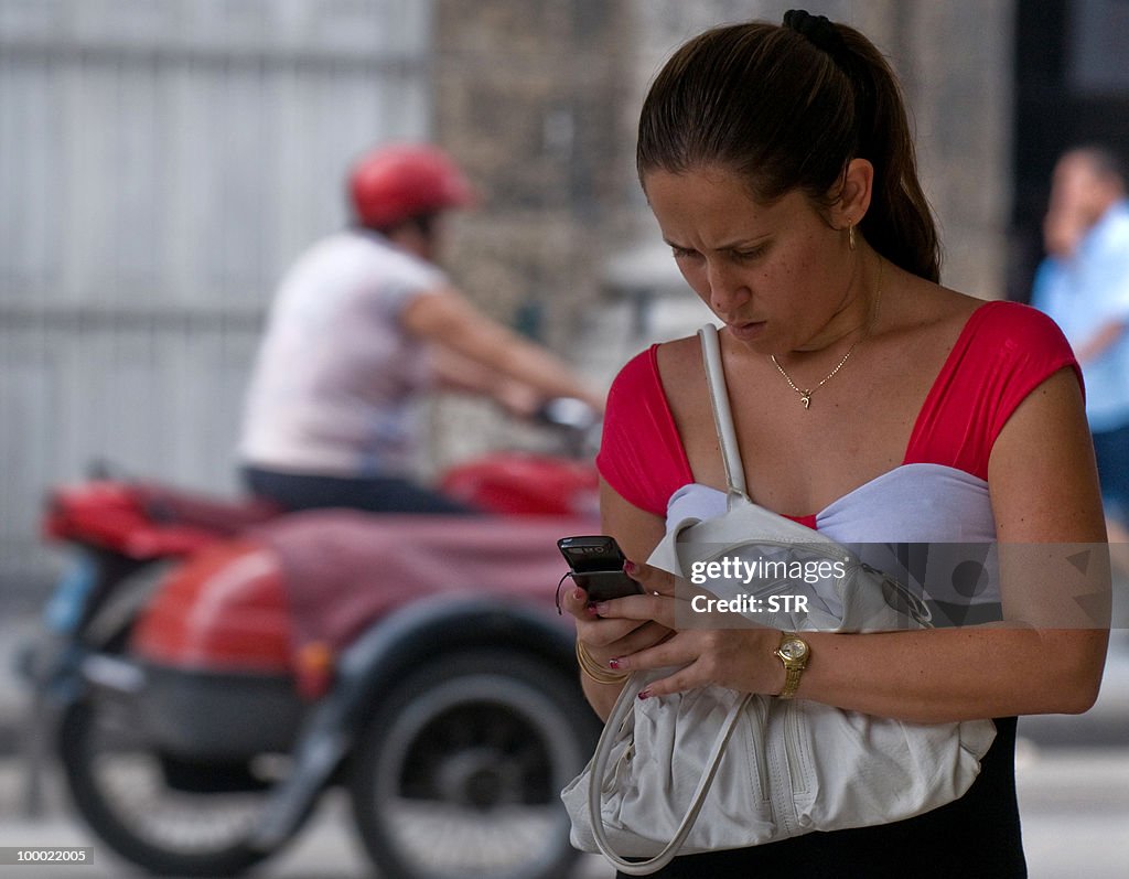 A Cuban woman uses her mobile phone in a