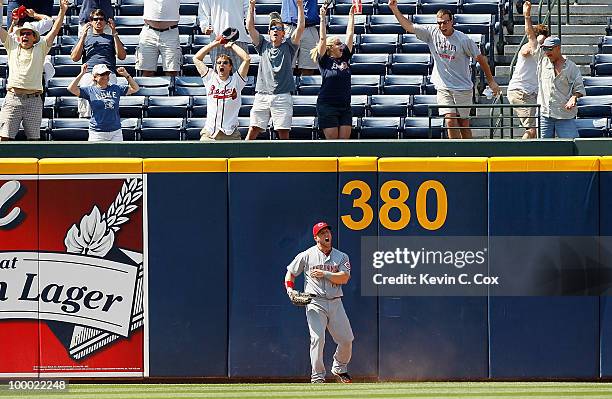 Leftfielder Laynce Nix of the Cincinnati Reds reacts after failing to catch the walk-off grand slam by pinch hitter Brooks Conrad of the Atlanta...