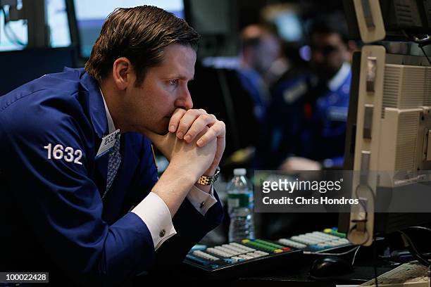 Financial professional looks over a screen on the floor of the New York Stock Exchange near the end of the trading day May 20, 2010 in New York City....
