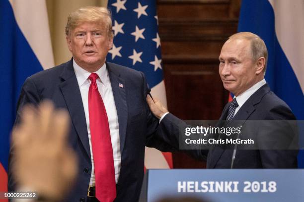 President Donald Trump and Russian President Vladimir Putin shake hands during a joint press conference after their summit on July 16, 2018 in...