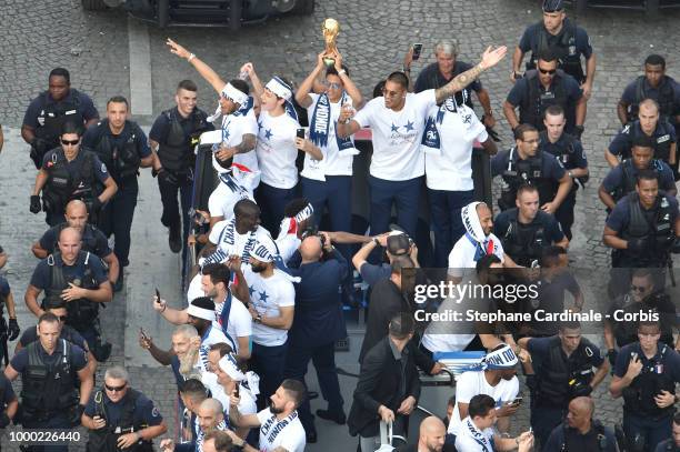 Corentin Tolisso, Benjamin Pavard, Raphael Varane holding the trophy, Alphonse Areola, Blaise Matuidi and Olivier Giroud celebrate with teammates on...