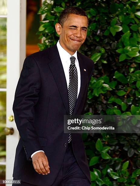 President Barack Obama winks as he walks out of the Oval Office before making remarks on financial reform legislation in the Rose Garden at the White...