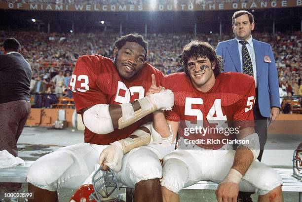 Orange Bowl: Oklahoma Lee Roy Selmon and Jimbo Elrod victorious on sidelines bench after winning National Championship game vs Michigan. Miami, FL...