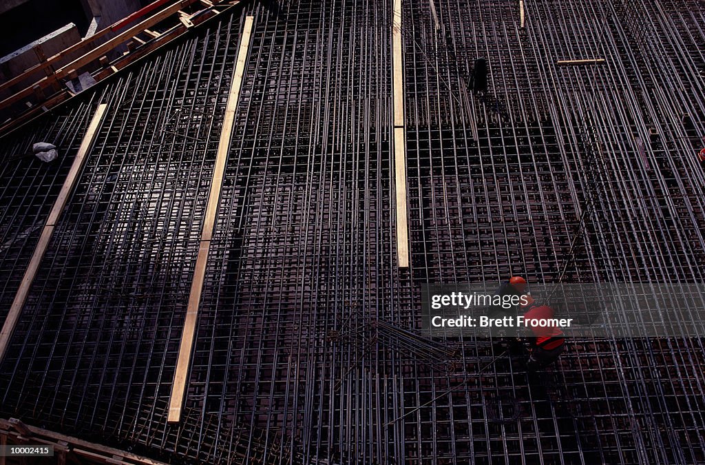 CONSTRUCTION WORKERS ON STEEL REBAR GRID