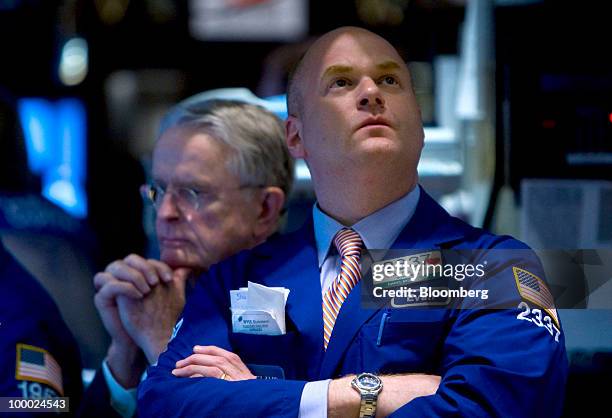 Evan Solomon looks up to check a monitor while working on the floor of the New York Stock Exchange in New York, U.S., on Thursday, May 20, 2010. U.S....